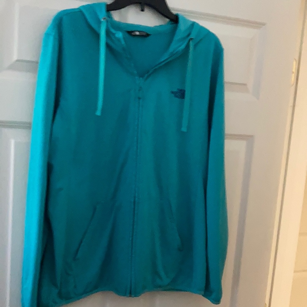 Light weight North Face zip up jacket with hood and thumb holes.